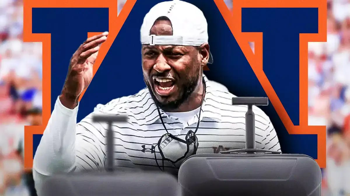 Photo: Cadillac Williams in Auburn gear with packed luggage and Auburn logo behind him