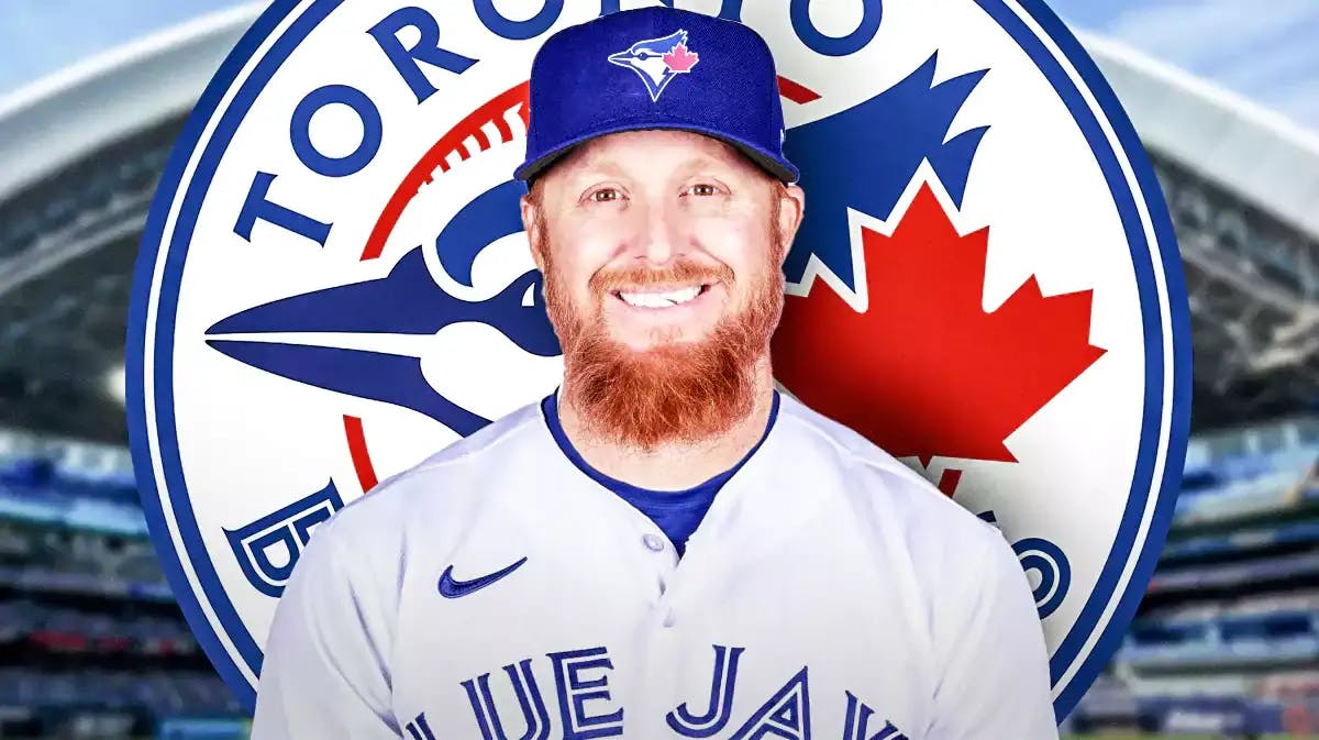 Justin Turner wearing a Blue Jays jersey in front of a Blue Jays logo at Rogers Centre