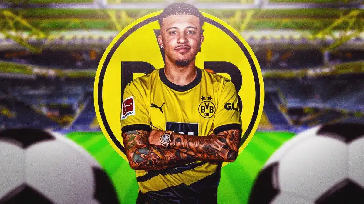 Jadon Sancho smiling in front of the Borussia Dortmund logo