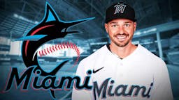 Trey Mancini wearing a Marlins jersey next to a Marlins logo in front of loanDepot Park.