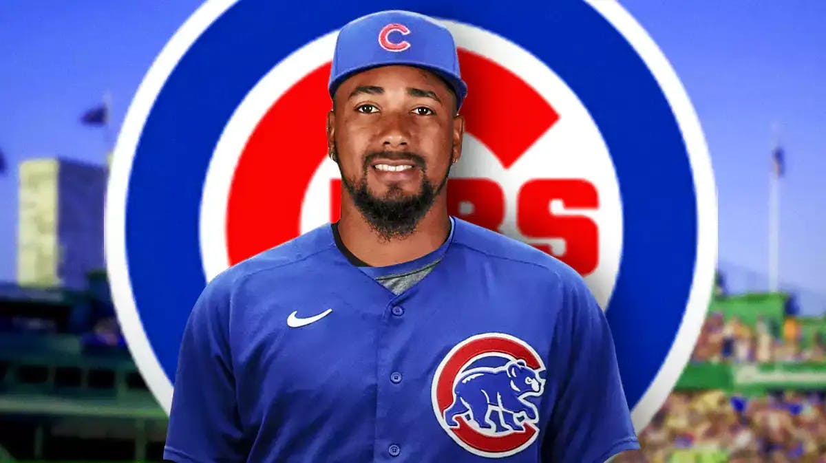 Guardians closer Emmanuel Clase wearing a Cubs jersey in front of a Cubs logo