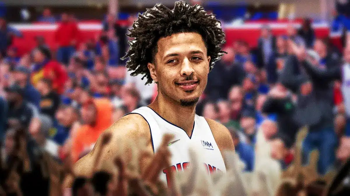Pistons fans excited, Cade Cunningham smiling.