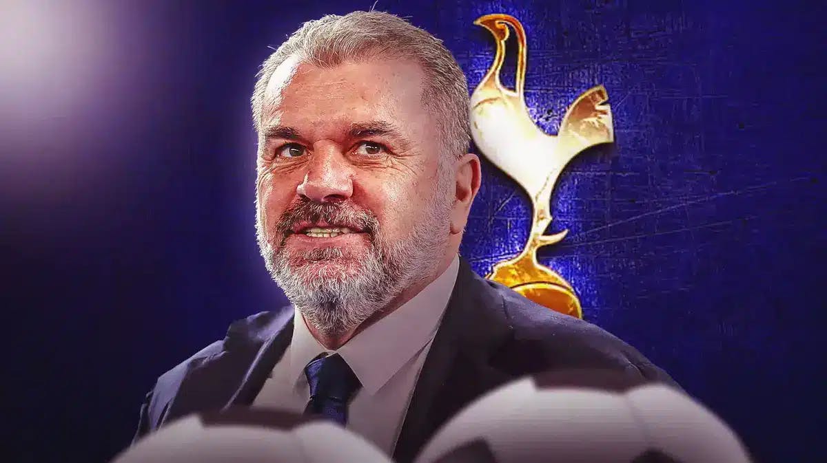 Ange Postecoglou laughing in front of the Tottenham logo