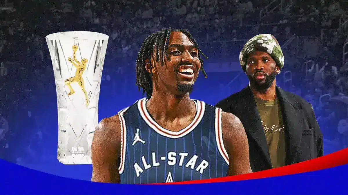 76ers' Tyrese Maxey smiling, with the 2024 All-Star Game uniform and the Most Improved Player trophy beside him and Joel Embiid (casual clothes) smiling at Maxey