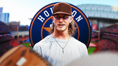 Josh Hader wearing normal clothes looking at the Houston Astros' logo.