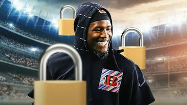 Bengals' Tee Higgins smiling, with padlocks all over him