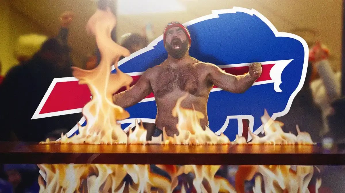 Jason Kelce yelling with a flaming table in front of him