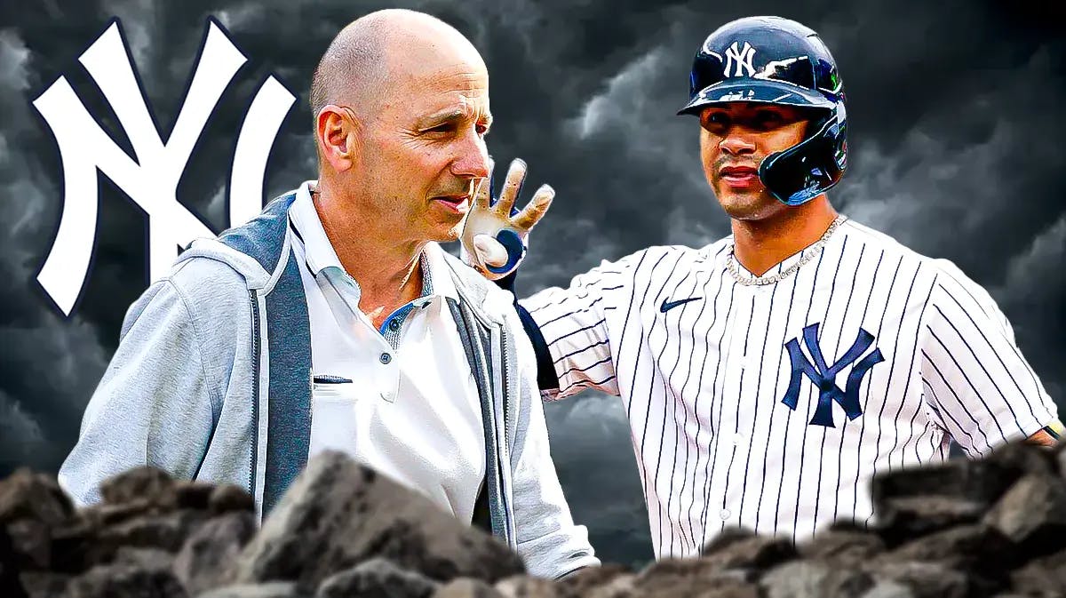 New York Yankees Gm Brian Cashman stands next to Gleyber Torres during a cloud storm, Gleyber Torres stats mentioned in background
