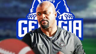 Georgia coach Dell McGee with georgia State logo behind him.