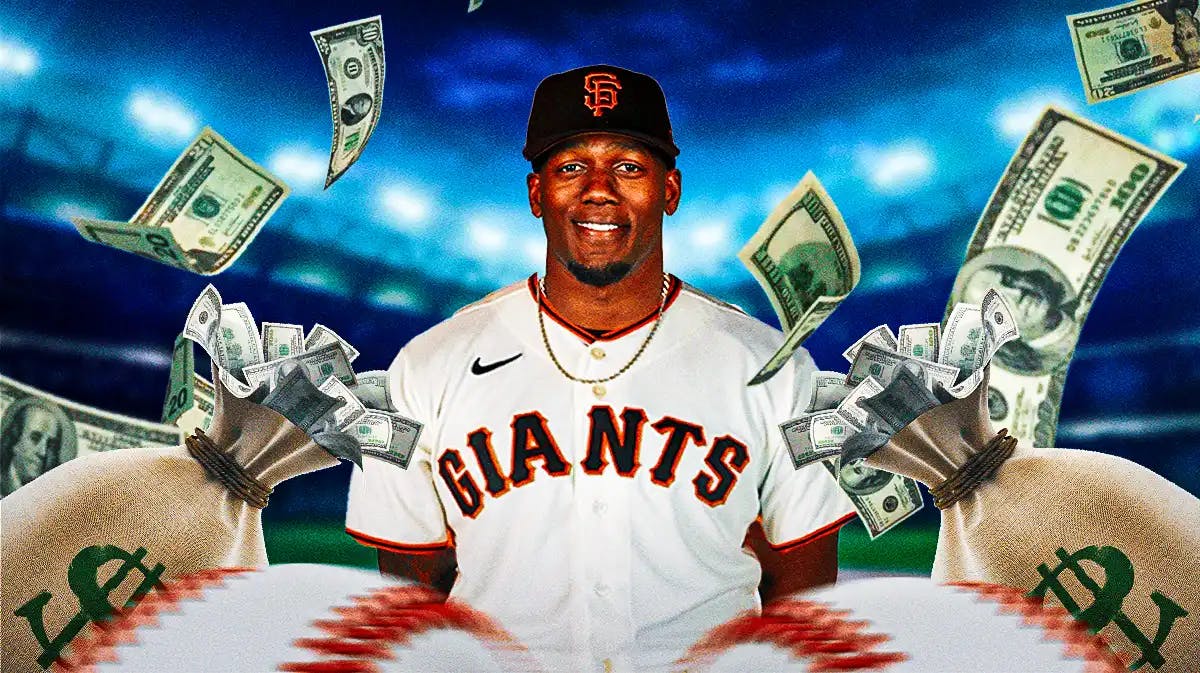 Giants' Jorge Soler with a big money bag and cash all around him.