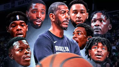 Nets coach Kevin Ollie in the middle from at least the waist up surrounded by the heads of Nets players Ben Simmons, Nic Claxton, Mikal Bridges, Cam Thomas, Dorian Finney-Smith, Day’Ron Sharpe, Dennis Schroder