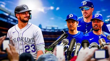Rockies' Kris Bryant standing on the left by himself. Nobody else around him. Place' Dodgers' Shohei Ohtani, Dodgers' Mookie Betts, and Dodgers' Freddie Freeman on right with microphones pointed toward them as if they are being interviewed.