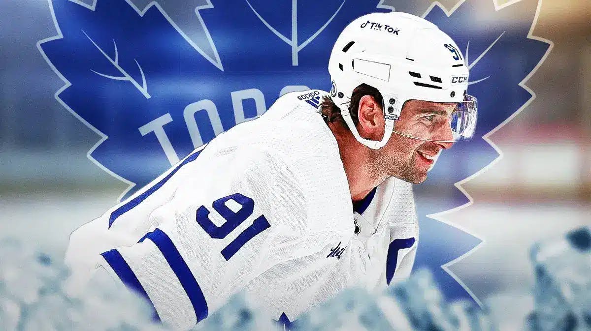 John Tavares in middle of image looking happy, TOR Maple Leafs logo, hockey rink