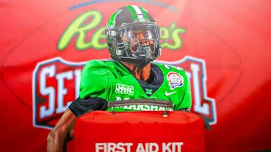 Marshall RB and NFL Draft prospect Rasheen Ali with a first aid kit in front of him and Senior Bowl background