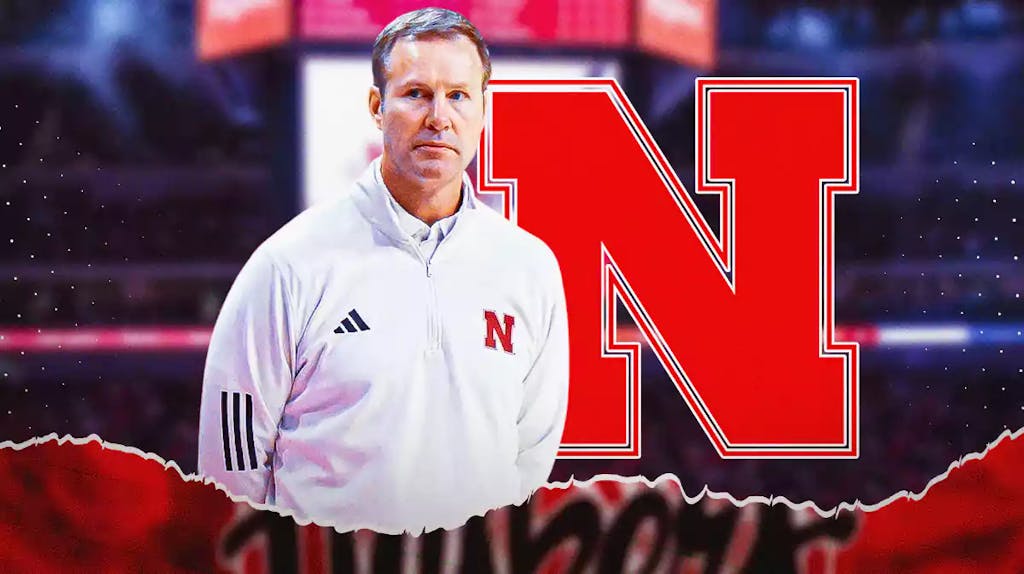Fred Hoiberg with the Nebraska Huskers logo in the background