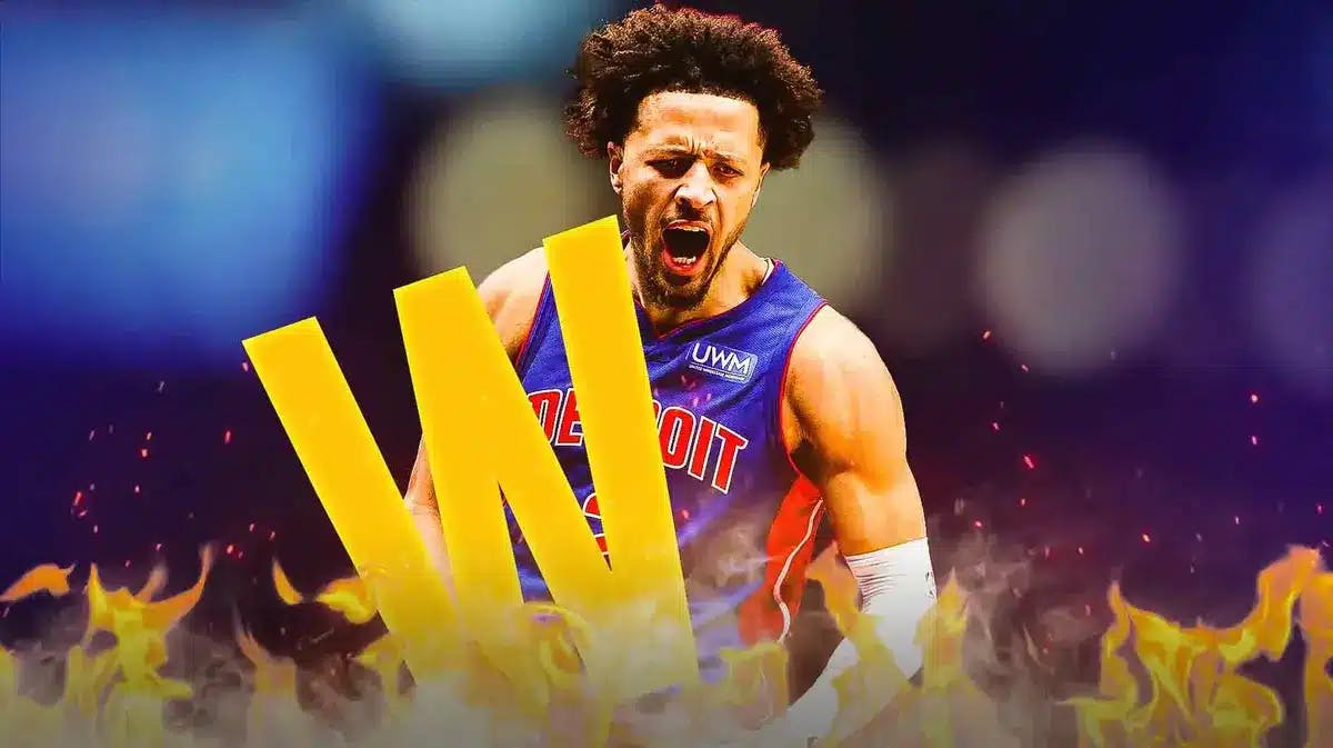 Pistons star Cade Cunningham looking hyped and on fire while holding a "W"