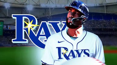 Amed Rosario in a Rays jersey next to a Rays logo