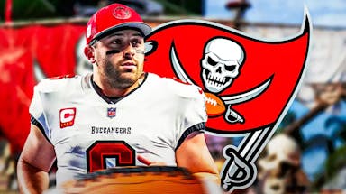 Buccaneers' Baker Mayfield stands in front of Bucs franchise tag flag before NFL Free Agency