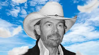 Toby Keith with sky background.