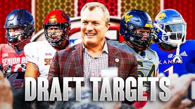 GM John Lynch in the middle, Taliese Fuaga, Zach Frazier, Khyree Jackson, Kenny Logan Jr around him, and San Francisco 49ers wallpaper in the background.
