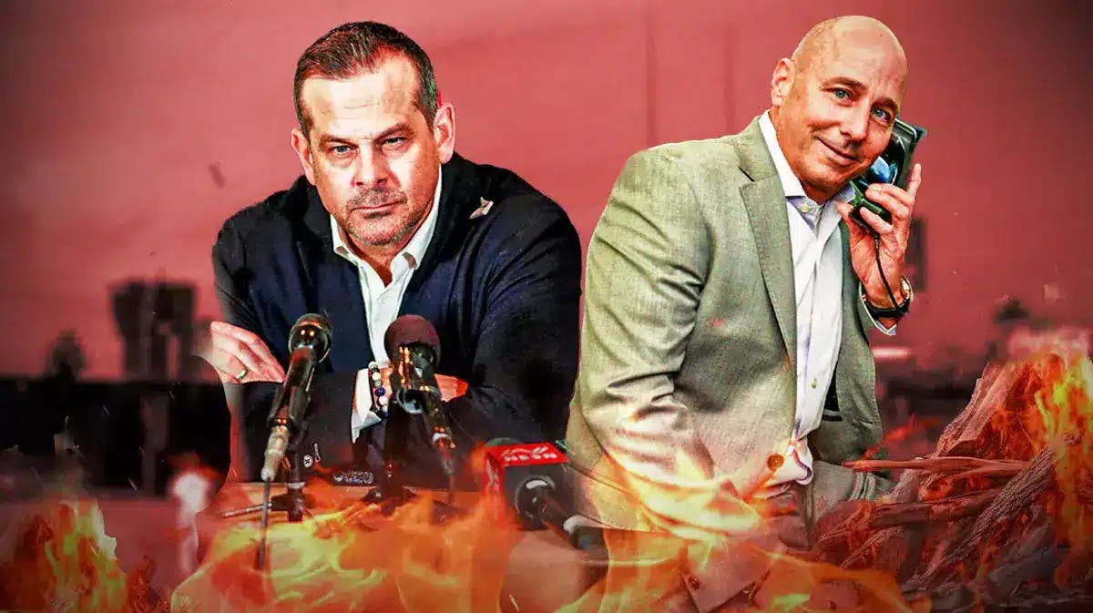 Yankees' Aaron Boone and Brian Cashman sitting on a seat with a campfire under it