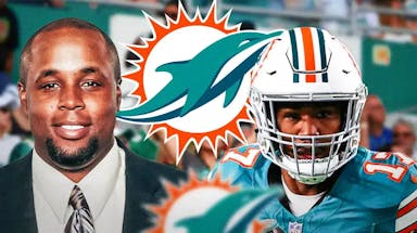 Chris Grier and Jaylen Waddle next to a Dolphins logo