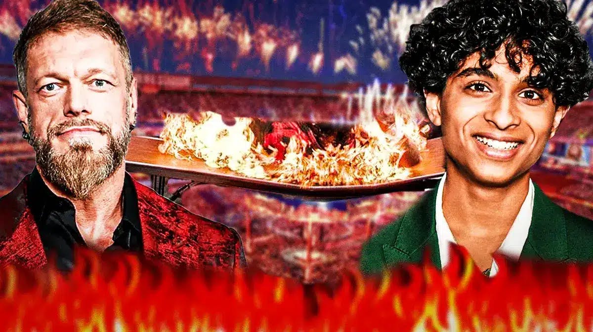Adam Copeland and Aryan Simhadri with WWE background and flaming table.