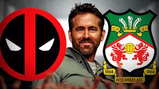 Ryan Reynolds smiling in front of the Deadpool and Wrexham logos