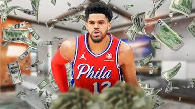 Tobias Harris surrounded by piles of cash.