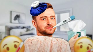 Justin Timberlake wrapped in a blanket with an ice pack on his head and thermometer in his mouth, holding a box of tissues