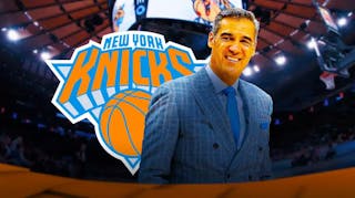 Photo: Jay Wright in suit with New York Knicks logo behind him