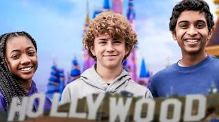 Percy Jackson and the Olympians cast Leah Sava Jeffries, Walker Scobell, and Aryan Simhadri with Disney World background.