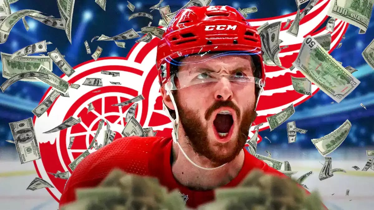 Michael Rasmussen in middle of image looking happy with money, DET Red Wings logo and hockey rink in background