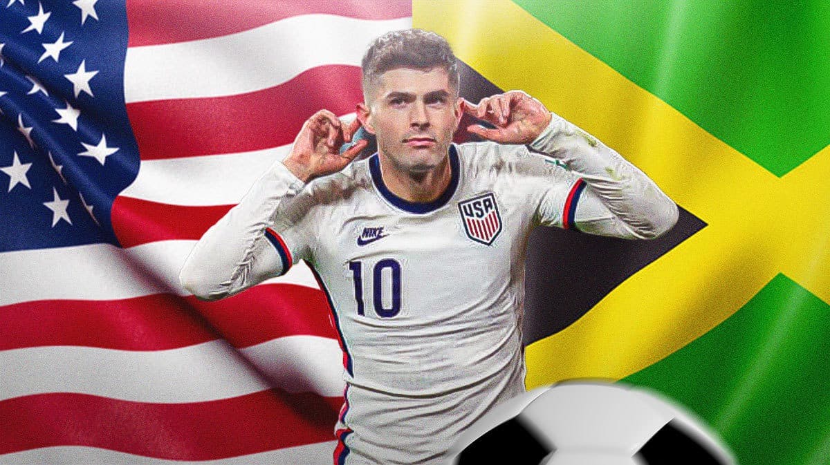Christian Pulisic celebrating in front of the USA and Jamaica flags