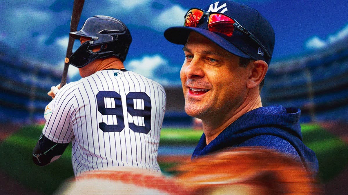 Aaron Judge but his back turned to viewer so we see his number. On left side of image, have Yankees' Aaron Boone smiling.