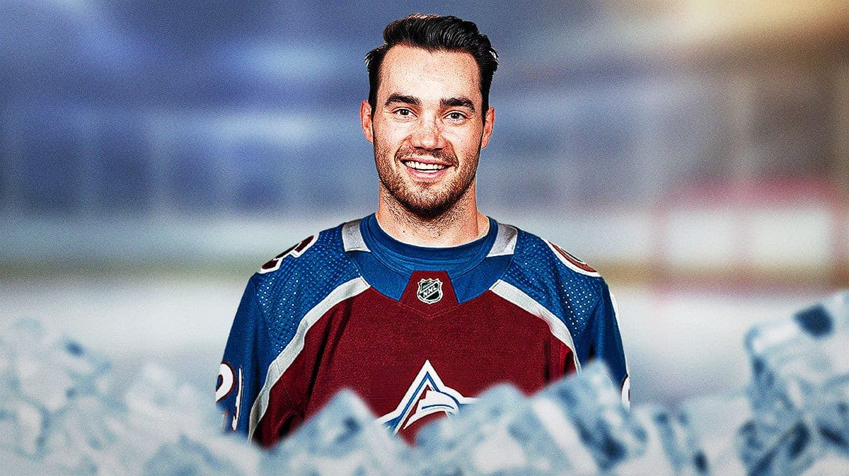 Sean Walker in a Colorado Avalanche jersey, no letter on jersey, hockey rink in background