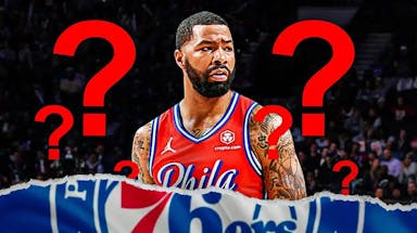 Marcus Morris in middle of image looking hopeful, 3-5 question marks, basketball court