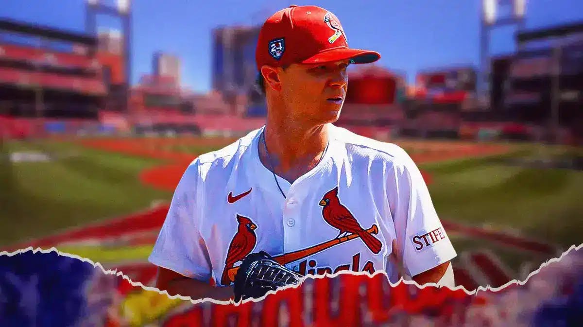 Cardinals' Sonny Gray looking down and serious while standing on a baseball pitching mound.