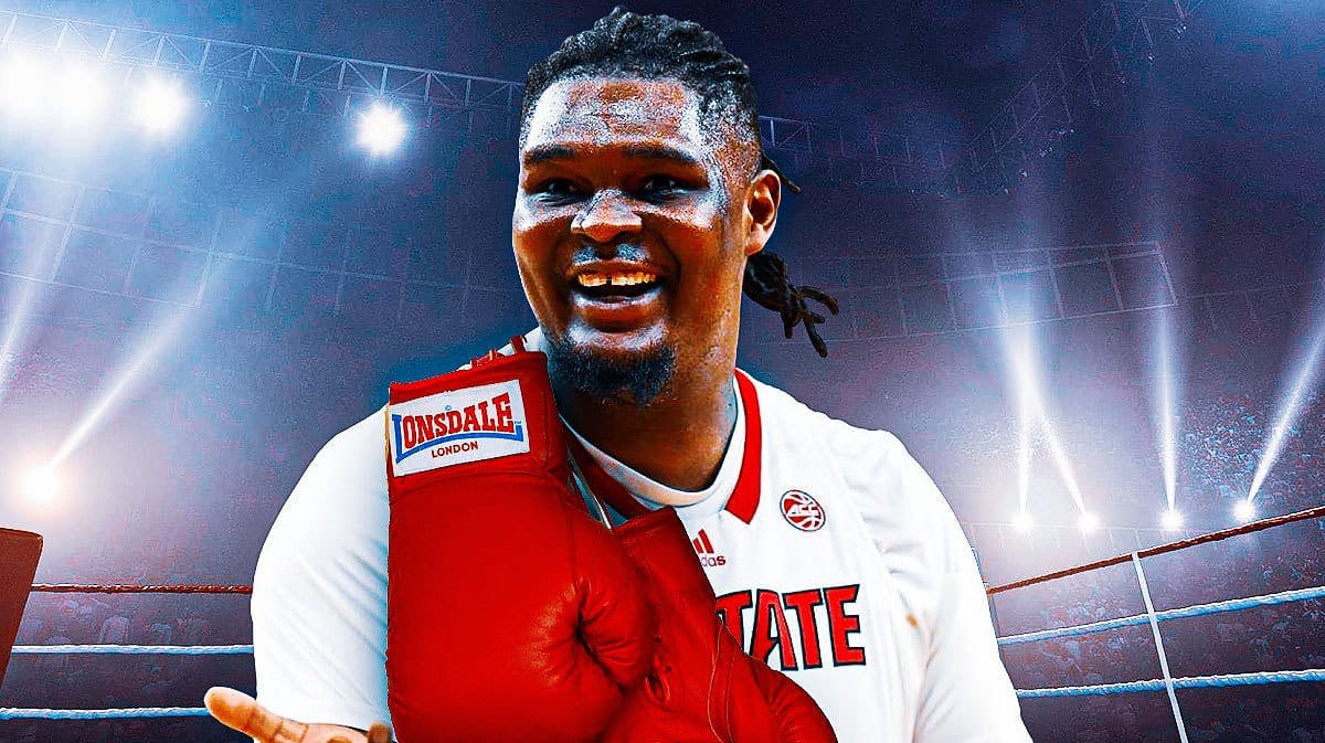 NC State Wolfpack big man DJ Burns with a pair of boxing gloves over his shoulder