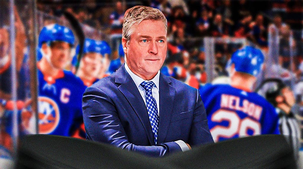 Islanders coach Patrick Roy, with players in background.