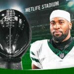 Haason Reddick in a Jets jersey next to the Lombardi Trophy at MetLife Stadium