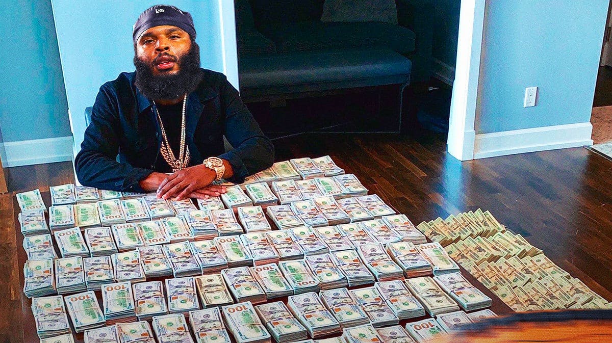 Isaiah Wynn (Dolphins) as Floyd Mayweather with stacks of money