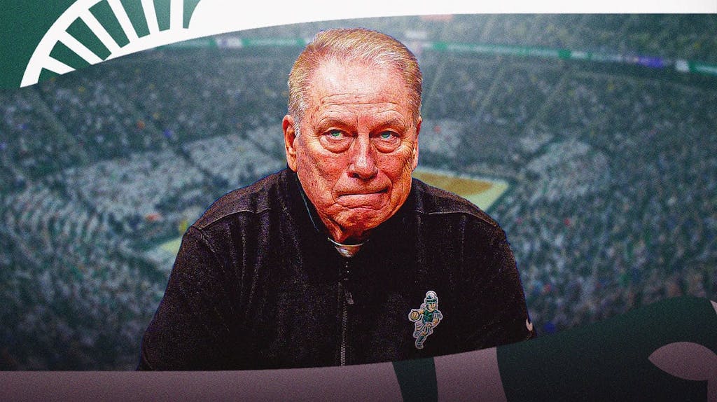 Tom Izzo, looking determined, Michigan logo in the background.
