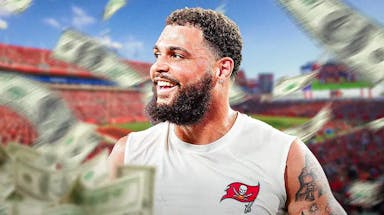 Mike Evans with money all around him. Buccaneers stadium or logo in the background