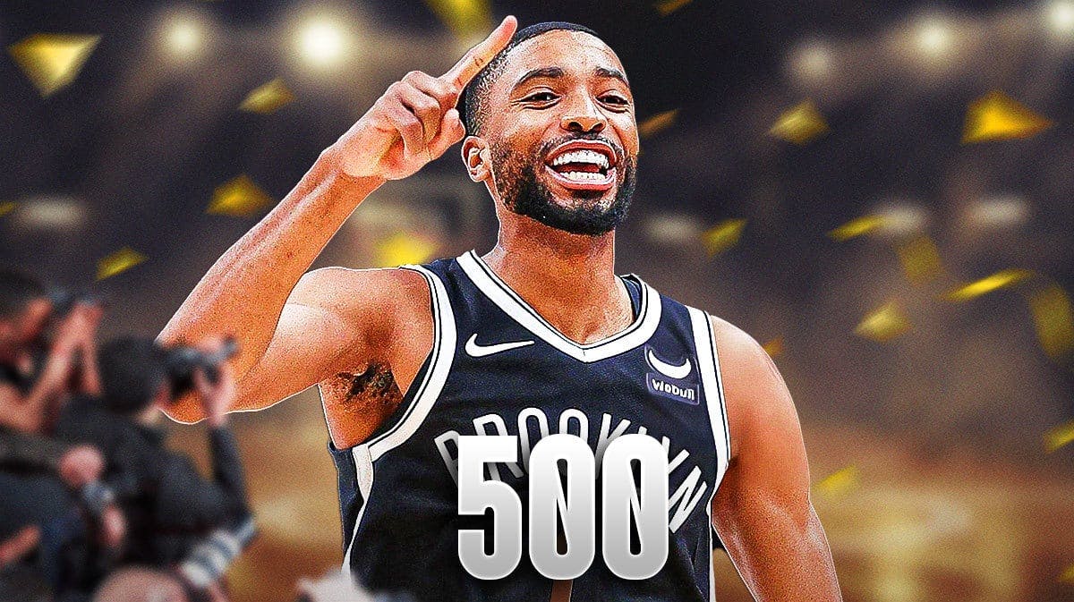 Mikal Bridges with “500” in front of him and confetti and part streamers around him.