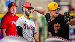 Paul Skenes pitching (Pirates) with Mike Trout and Bryce Harper smiling behind him