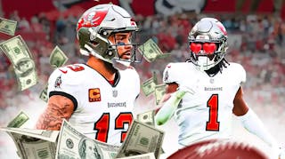 Photo: Rachaad White with heart eyes looking at Mike Evans with money flying around him, both in Buccaneers jerseys