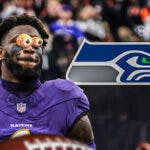 Baltimore Ravens linebacker Patrick Queen with his eyes bugged out looking at Seattle Seahawks logo.