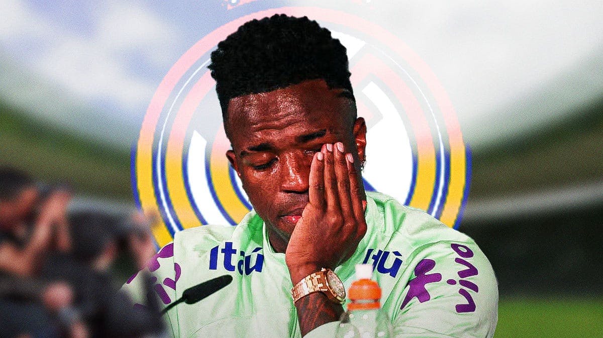 Vinicius Jr crying in front of the Real Madrid logo