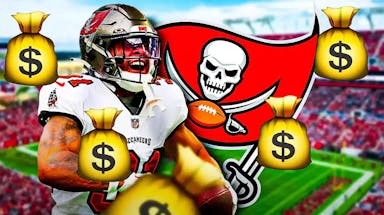 Buccaneers Antoine Winfield Jr next to a Buccaneers logo and surrounded by money at Raymond James Stadium